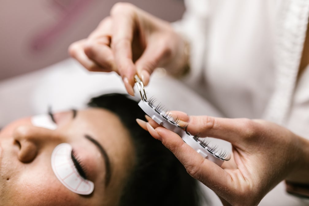 Person Holding a Set of False Eyelashes